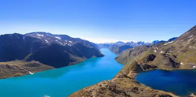 an aerial view of a lake between two mountains at Beitostølen! Midt i sentrum! Ski in ski out! Badstue-Massasjedusj-Steamdusj in Beitostøl