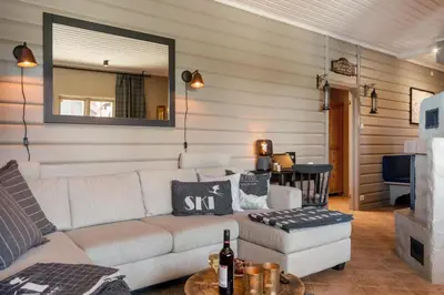 a living room with a couch and a mirror at Beitostølen! Midt i sentrum! Ski in ski out! Badstue-Massasjedusj-Steamdusj in Beitostøl