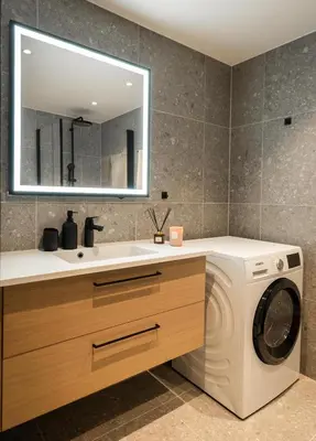 a bathroom with a washing machine and a sink at Vister, Hemsedal - fine leiligheter rett ved Fyri Resort - Ski inn - Ski out in Hemsedal