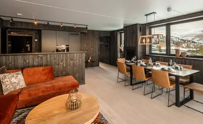 a living room with a couch and a table at Vister, Hemsedal - fine leiligheter rett ved Fyri Resort - Ski inn - Ski out in Hemsedal