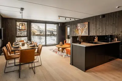 a kitchen and dining room with a table and chairs at Vister, Hemsedal - fine leiligheter rett ved Fyri Resort - Ski inn - Ski out in Hemsedal