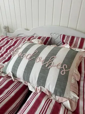 a bed with a black and white striped blanket on it at Familievennlig fritidsbolig i hjertet av Flå, perfekt for besøk i Bjørneparken in Flå