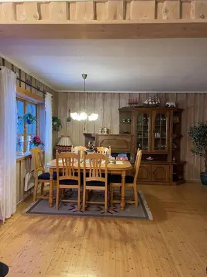 a dining room with a wooden table and chairs at Familievennlig fritidsbolig i hjertet av Flå, perfekt for besøk i Bjørneparken in Flå