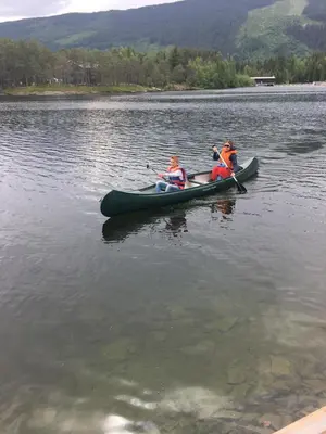 two people in a canoe on a lake at Rønlund Hyttepark, Midgard in Ron