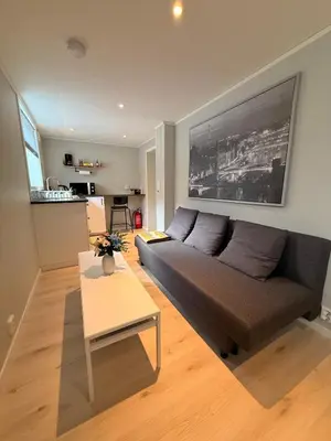 a living room with a couch and a table at Cozy basement apartment in Orkanger in Orkanger