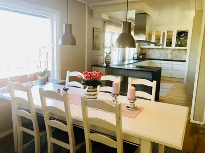 a kitchen with a table and chairs with candles on it at Solrikt og sentralt. Ta med både to og firbeinte in Lillehammer