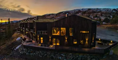 an aerial view of a house with lights on at Trilodge - Unique cabin with high standard, views, ski in & out, attractive location in Meråker
