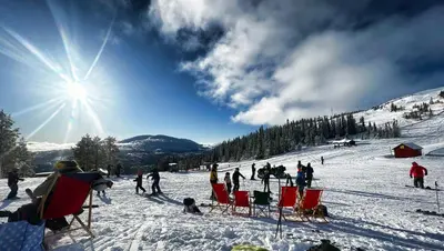 a group of people sitting in chairs on a ski slope at Trilodge - Unique cabin with high standard, views, ski in & out, attractive location in Meråker
