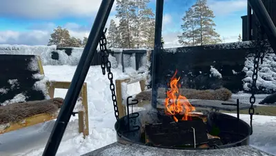 a fire pit with snow in a yard at Trilodge - Unique cabin with high standard, views, ski in & out, attractive location in Meråker