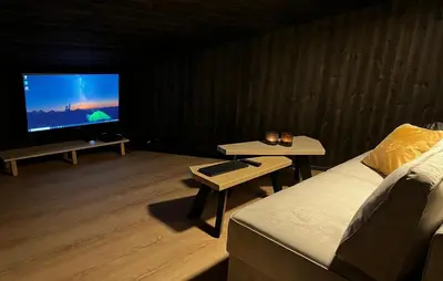 a living room with a couch and a flat screen tv at Trilodge - Unique cabin with high standard, views, ski in & out, attractive location in Meråker