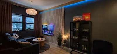a living room with a couch and a tv at Moderne cityleilighet Sogndal in Sogndal