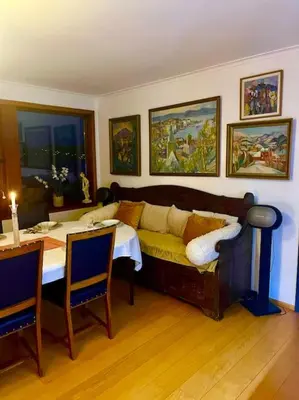 a living room with a couch and a table at Villa med panoramautsikt, stor uteplass og 100 m fra badestrand in Bergen