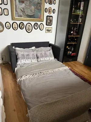 a large bed in a room with clocks on the wall at Villa med panoramautsikt, stor uteplass og 100 m fra badestrand in Bergen