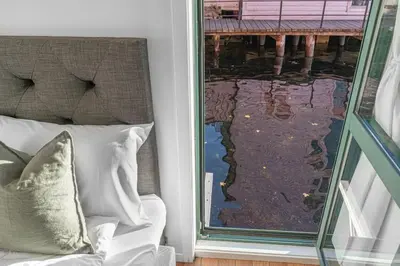 a window with a couch and a view of the water at Seaside Apt. Catch Crabs from Your Bedroom Window! in Bergen