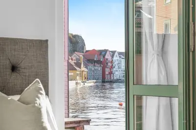 a room with a window with a view of a river at Ocean-view Haven: Take a swim from your window! in Bergen