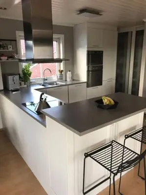 a kitchen with a black counter top in a room at Spacious house near city centre - WSC 2025! in Trondheim
