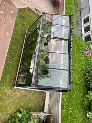 a glass greenhouse on the side of a house at Spacious house near city centre - WSC 2025! in Trondheim