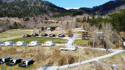 an aerial view of a village in the mountains at Gjerdset Turistsenter in Isfjorden