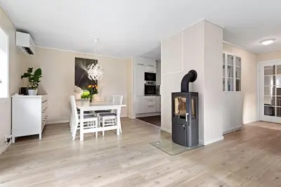 a kitchen and dining room with a stove in a room at Fint hus i Flåm in Aurland