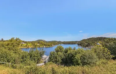 a view of a river with trees in the background at Cozy Apartment In Sveio With Kitchen in Sveio