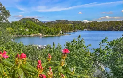 a view of a body of water with pink flowers at Cozy Apartment In Sveio With Kitchen in Sveio