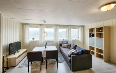a living room with a couch and a table at Cozy Apartment In Sveio With Kitchen in Sveio