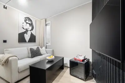 a living room with a couch and a tv at King bed - Renovated 2024 - 2BR Behind Bryggen in Bergen