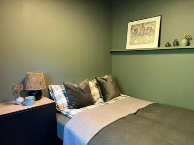 a bedroom with a bed and a table with a lamp at Sognefjorden View in Leikanger