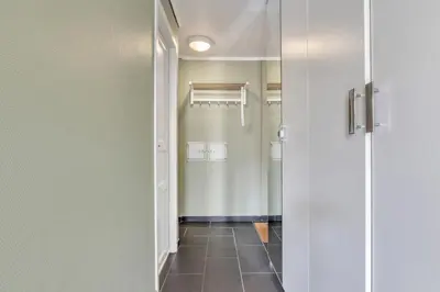 a bathroom with a walk in shower next to a door at Easy Living in Bergen