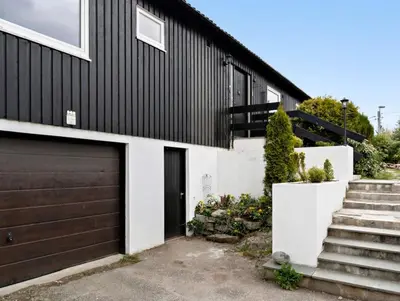 a black and white house with a garage at Tranquil Haven Villa in Ålesund