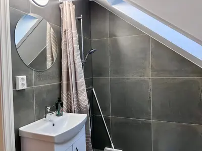 a bathroom with a sink and a mirror at Fjord-View Retreat with Free Parking and Fast Internet in Nese