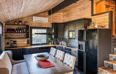 a kitchen with a table and a refrigerator at Awesome Home In Fevåg With Wifi in Fevåg