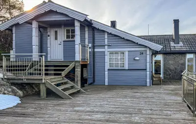 a blue house with a wooden ramp in front of it at Awesome Home In Fevåg With Wifi in Fevåg