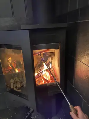 a person is cooking in a brick oven at Hytta for 8 personer skiut/inn in Trysil