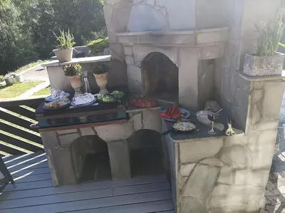a outdoor oven with food on a patio at Fritt beliggende stor enebolig med høy standard in Rjukan