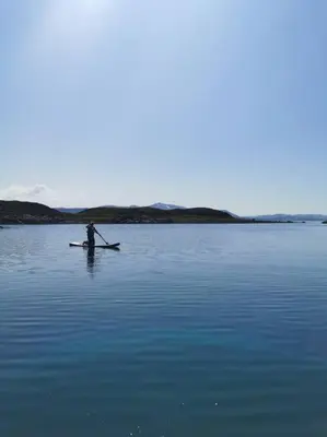 a person in a kayak on a large body of water at Stabburet på Balsnes Gård in Hitra