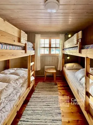 a bedroom with two bunk beds and a window at Family-friendly cabin at Sjusjøen with ski trails, sauna and fireplace in Ringsaker