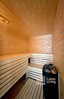 a large wooden sauna with a trash can in it at Family-friendly cabin at Sjusjøen with ski trails, sauna and fireplace in Ringsaker