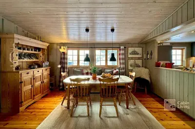 a kitchen with a table and chairs in a room at Family-friendly cabin at Sjusjøen with ski trails, sauna and fireplace in Ringsaker