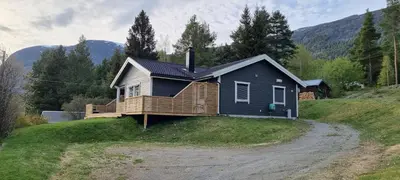 a house sitting on top of a grassy hill at Hus i flott natur in Skjåk