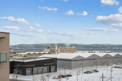 a view of a large building with snow on the ground at Modern and central Apartment - Solsiden Trondheim - Up to 6 people in Trondheim
