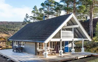 a house with a metal roof on a wooden deck at Gorgeous Home In Uvdal With Wifi in Uvdal