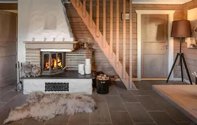 a living room with a fireplace and a staircase at Gorgeous Home In Uvdal With Wifi in Uvdal