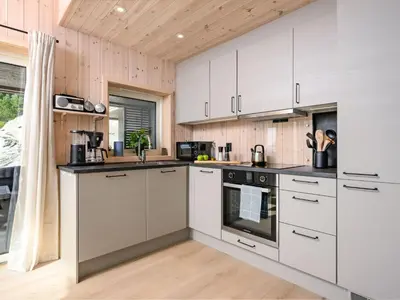 a kitchen with white cabinets and a stove at Holiday Home Hildebu by Interhome in Sørbø