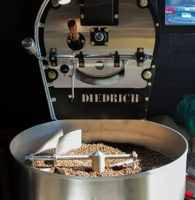 a coffee machine with a container of coffee beans at Bed and Brunsj, Sand in Sand
