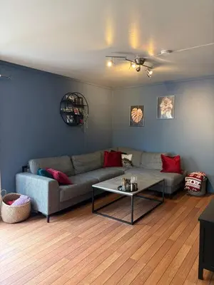 a living room with a couch and a table at Sentrumsnært hus in Rjukan