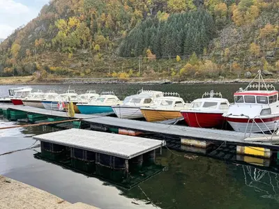 a group of boats docked at a dock in the water at 3 person holiday home in Flatraket-By Traum in Barmen