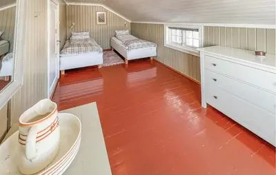 a small room with two beds and a table with a cup at Gorgeous Home In Svatsum With Wifi in Svingvoll