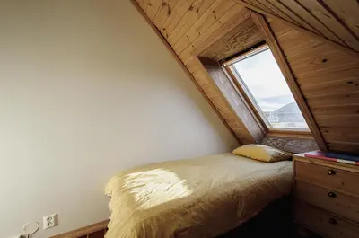 a bedroom with a bed in a room with a window at The View - BIG Apartment in City Center in Bergen