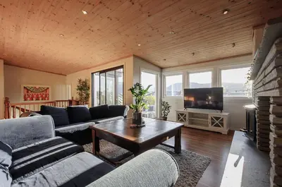a living room with couches and a table and a tv at The View - BIG Apartment in City Center in Bergen